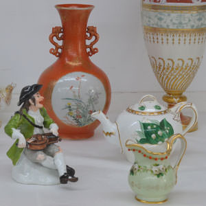 A small selection of ceramics from across the world: German Meissen figure, Irish Belleek pottery, Chinese Iron red, English Minton pate sur pate.